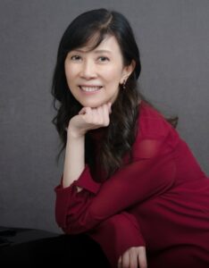 Photo of Alice Ho, an Asian woman with long black hair, wearing a dark red shirt